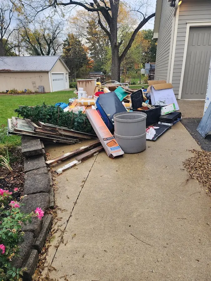 Dumpster being loaded with debris for 12 Yard Dumpster Rental in Crystal City